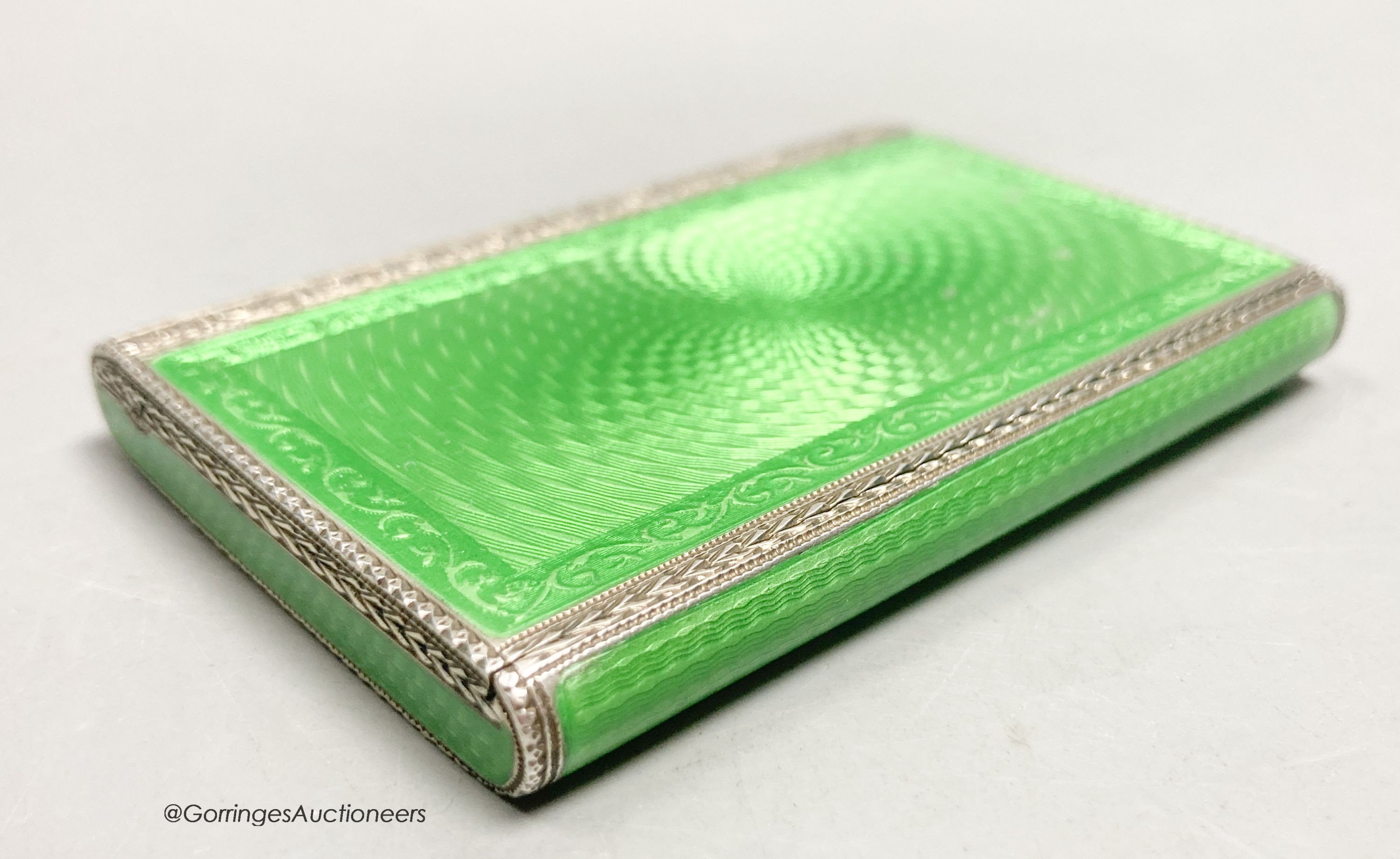 A 1920's continental silver and green guilloche enamel rectangular box and hinged cover, import marks for Cohen & Charles, London, 1927, 79mm by 54mm by 10mm